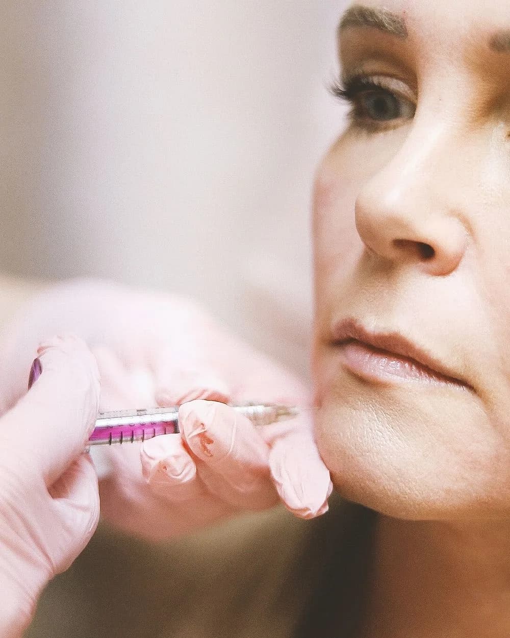 A clinician performing an injectable treatment on a patient