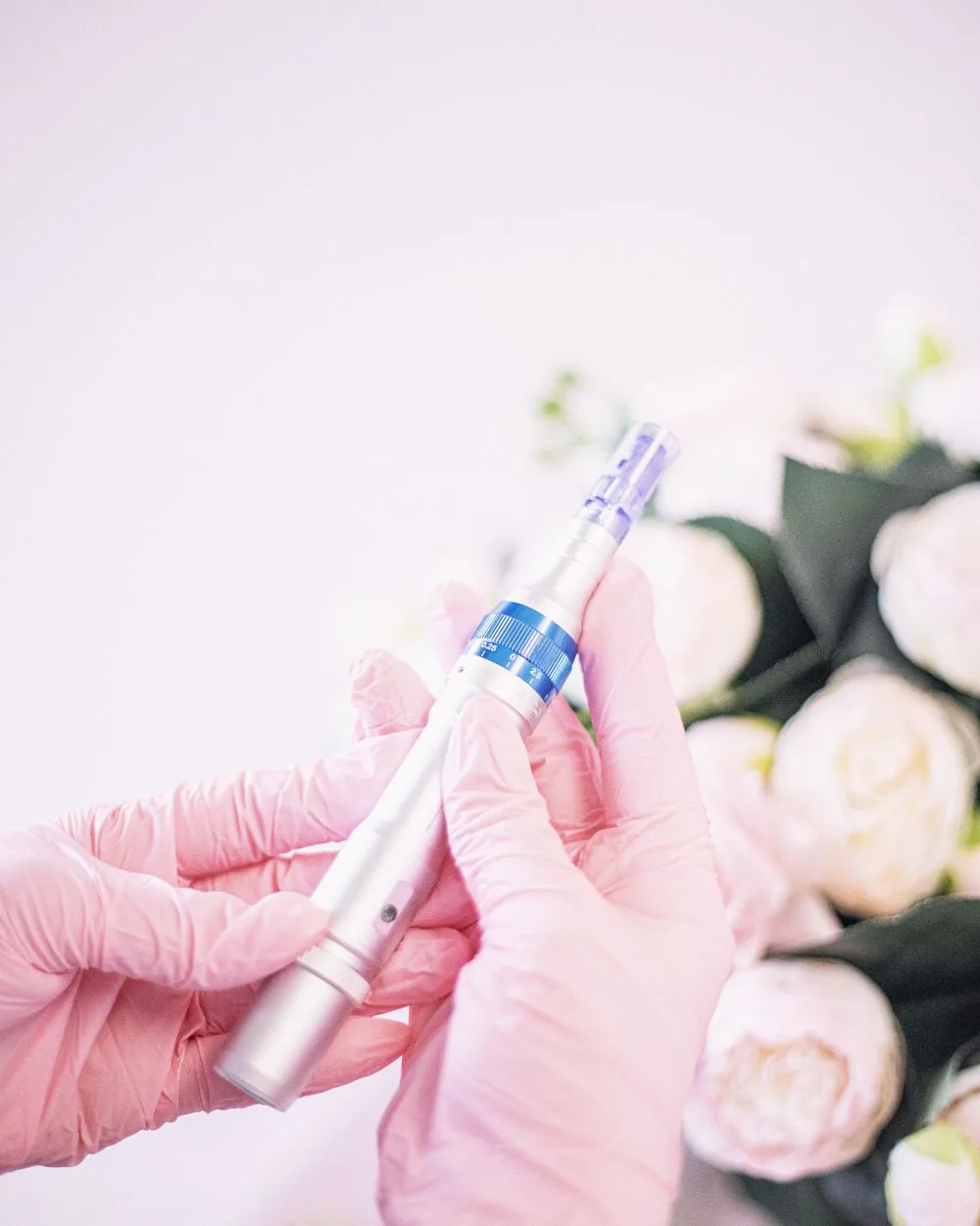 A gloved clinician preparing a treatment device