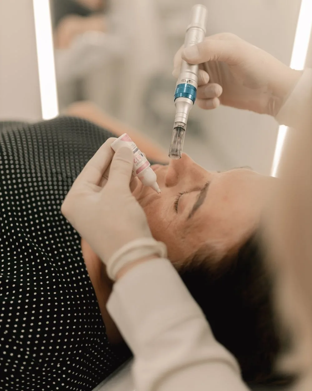 A clinician performing a microneedling treatment on a patient